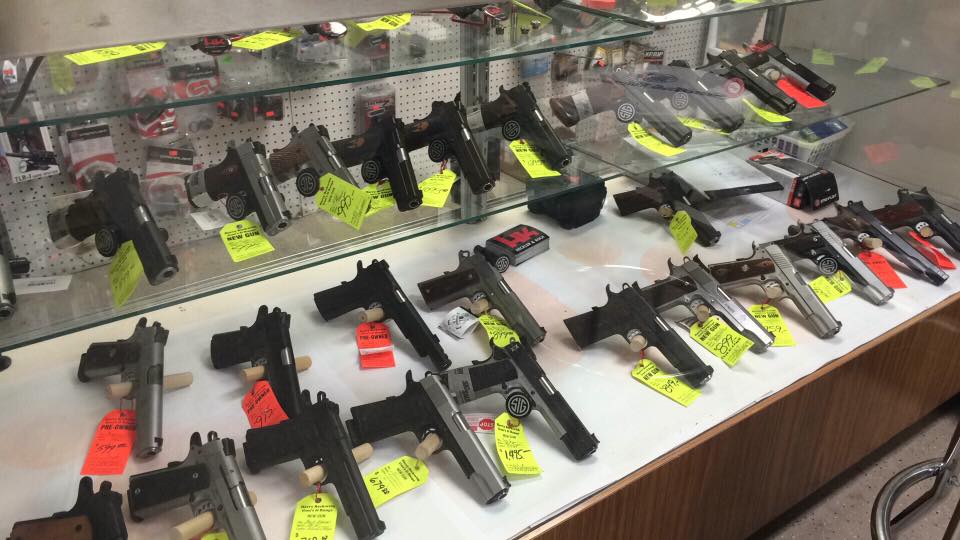 A display case filled with lots of guns.