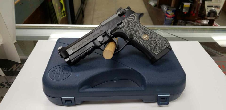 A gun that is sitting on top of a case.