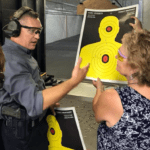 A man and woman holding up a yellow target.