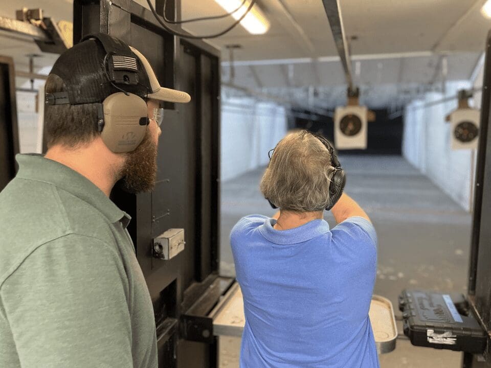 A man and woman are looking at the target.