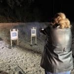 Person practicing shooting at outdoor range.