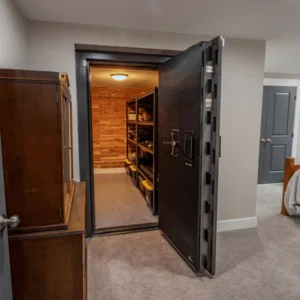 A room with a door open and shelves in it.