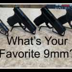 A table with three different types of guns on it.