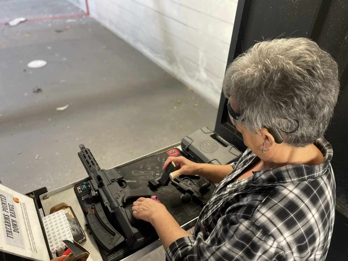A man working on an old typewriter in a room.